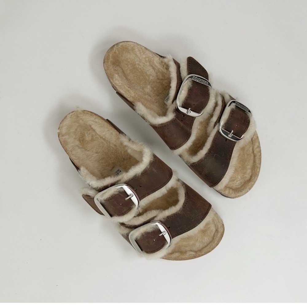 Brown Birkenstock Arizona shearling sold at free people.